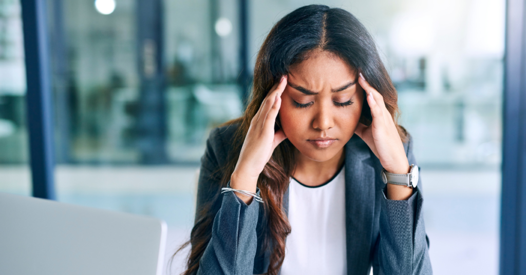 woman stressed at work because of loud noise